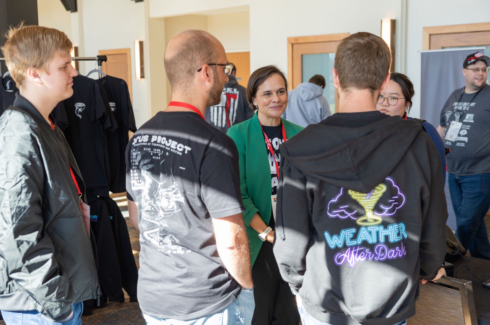The OTUS Project community gathered beside Weather After Dark merchandise